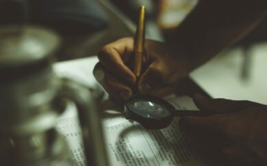 Searching through a book with a magnifying glass